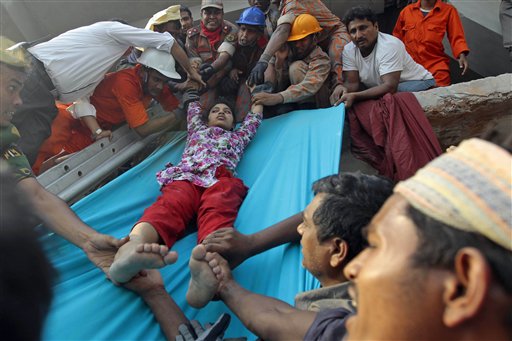 Rescuers lower down a survivor from the debris of the building that collapsed in Savar, Bangladesh, on Wednesday.