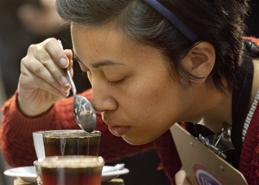 One of the judges tests the aroma of a brewed entry at the United States Barista Championship in Boston on Thursday. Competitors' creations are judged on taste, procedure, consistency, cleanliness and technical details including whether they are wasting precious coffee.