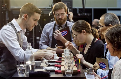 Barista competitor Nick Purvis, left, of Santa Barbara, Calif., presents one of his brewed entries to a panel of judges at the annual United States Barista Championship in Boston.