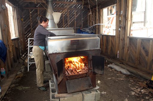 Johanna Lake checks the evaporator March 29 at David Moore's Crooked Chimney sugarhouse in Lee, N.H. Moore, New Hampshire's only known commercial birch syrup producer, got his start in 2008, when he was a student at the University of New Hampshire.