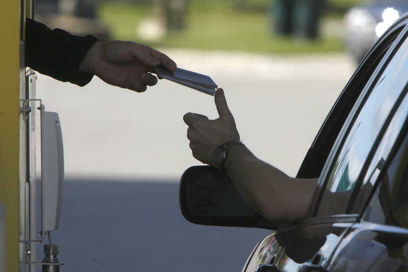 A driver hands his passport to a border agent at the U.S. border crossing in Highgate Springs, Vt.