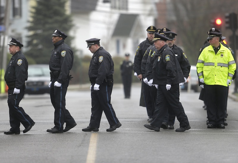 Police officers march in formation as they enter St. Patrick's Church, in Stoneham, Mass., before a funeral Mass for Massachusetts Institute of Technology police officer Sean Collier Tuesday, April 23, 2013. Collier was fatally shot on the MIT campus Thursday, April 18, 2013. Authorities allege that the Boston Marathon bombing suspects were responsible. (AP Photo/Steven Senne)