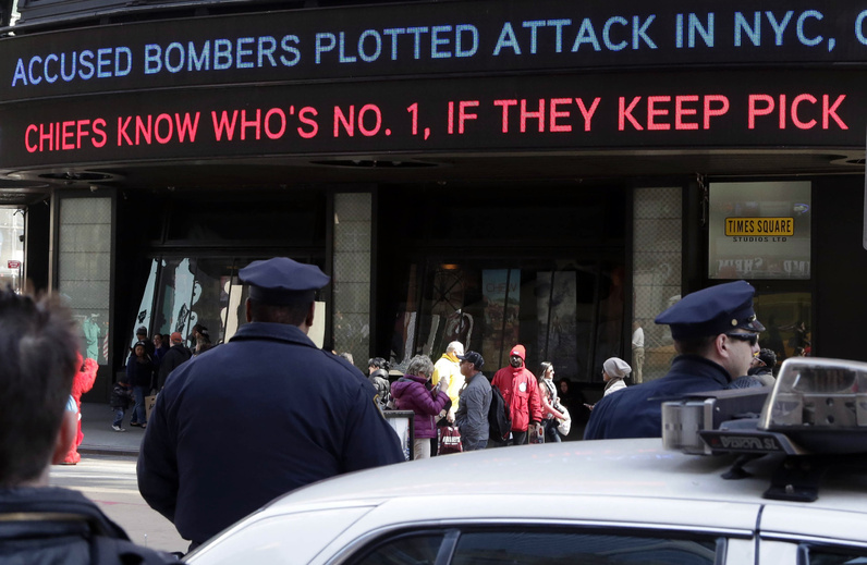 News headlines circle a building in New York's Times Square on Thursday, announcing that the Boston Marathon bombing suspects had planned to blow up their remaining explosives in New York's Times Square, officials said.
