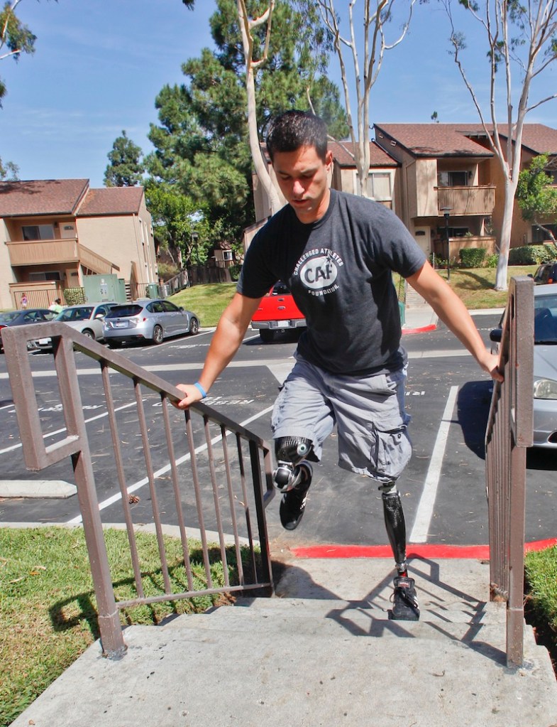 In this Thursday, Oct. 4, 2012 file photo, U.S. Marine Cpl. Daniel Riley, 21, navigates the steps outside his apartment on his prosthetic legs in San Diego, Calif. Riley lost both legs to an IED in Afhganistan. Nearly 2,000 American troops have lost a leg, arm, foot or hand in Iraq or Afghanistan, and their sacrifices have led to advances in the immediate and long-term care of survivors, as well in the quality of prosthetics that are now so good that surgeons often chose them over trying to save a badly mangled leg. (AP Photo/Lenny Ignelzi)