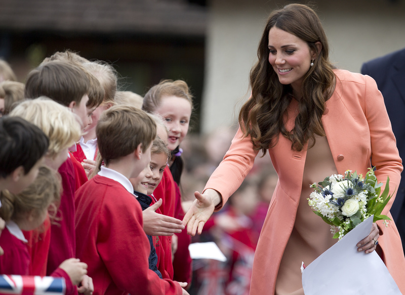 Kate, Duchess of Cambridge, shakes hands with schoolchildren after an official visit to Naomi House near Winchester, England, on Monday. Naomi House is a care home for children and young adults who have terminal conditions.