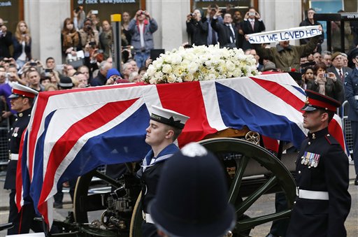 A Union flag draped coffin bearing the body of former British Prime Minister Margaret Thatcher is carried on a gun carriage drawn by the King's Troop Royal Artillery during her ceremonial funeral procession in London on Wednesday.