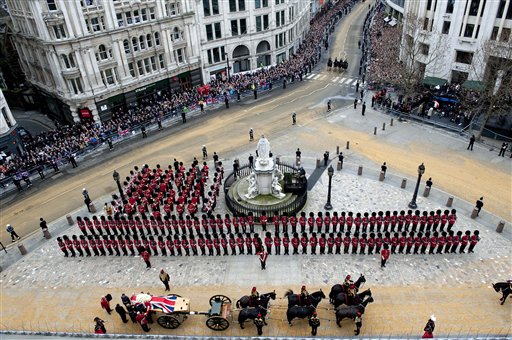A Union flag draped coffin bearing the body of former British Prime Minister Margaret Thatcher is carried on a gun carriage drawn by the King's Troop Royal Artillery during her ceremonial funeral procession in London on Wednesday.