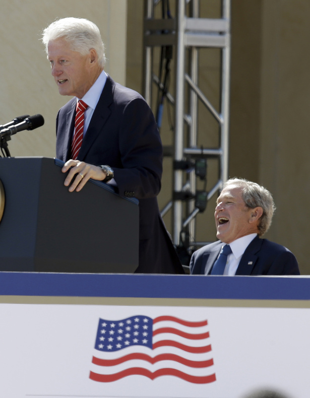 Former President George W. Bush laughs as former President Bill Clinton speaks at the dedication of the George W. Bush Presidential Center on Thursday in Dallas.