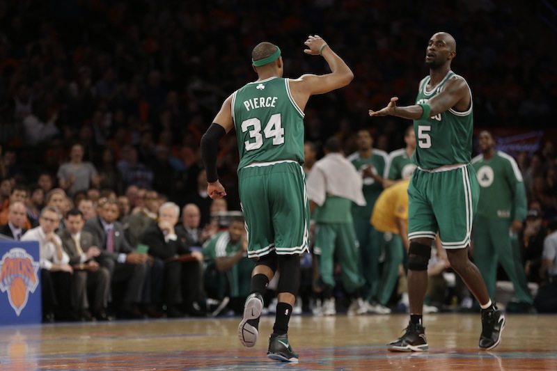 Boston Celtics forward Paul Pierce (34) and Celtics center Kevin Garnett (5) react in the second half of Game 1 of the NBA basketball playoffs in New York, Saturday, April 20, 2013. (AP Photo/Kathy Willens)