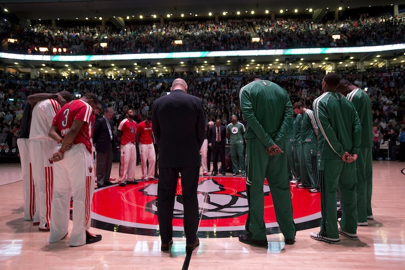 Toronto Raptors and Boston Celtics players observe a moment of silence for the victims of the Boston Marathon bombings before an NBA basketball game in Toronto, Wednesday April 17, 2013. (AP photo/The Canadian Press, Frank Gunn) basketball;Raptors;Association;athlete;athletes;athletic;athletics;Canada;Canadian;competative;compete;competing;competition;competitions;court;entertainment;event;game;league;National;NBA;player;players;pro;professional;sport;sporting;sports;Toronto
