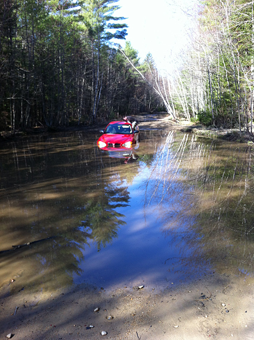 This photo provided by Lebanon Rescue shows the 2005 Pontiac Grand Am that got stuck Friday in a flooded section of Lord Road, which becomes impassable every spring.