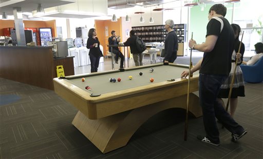 Google employees shoot pool at in a break room at the Google campus in Mountain View, Calif., recently. Companies say extraordinary campuses are a necessity, to recruit and retain top talent, and to spark innovation and creativity in the workplace.