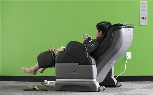 Google software engineer Jiang Chen sits in a massage chair at a Google campus building in Mountain View, Calif.