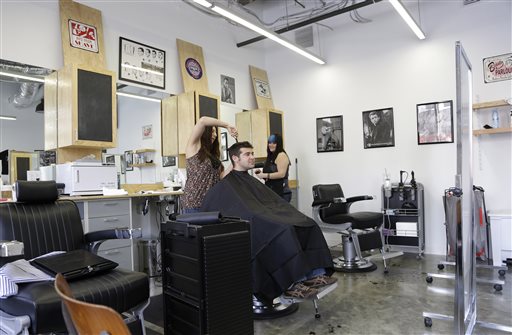 Facebook employee Noah Singer gets his hair cut by Charlotte Schaetzle at Johnny D's Barber Shop on the Facebook campus in Menlo Park, Calif.
