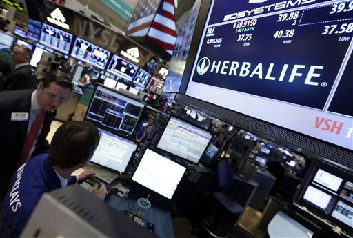 Trading specialists confer at the post that handles Herbalife at the New York Stock Exchange. Accounting firm KPMG resigned as the auditor for Herbalife and Skechers after a partner allegedly leaked information about the companies.