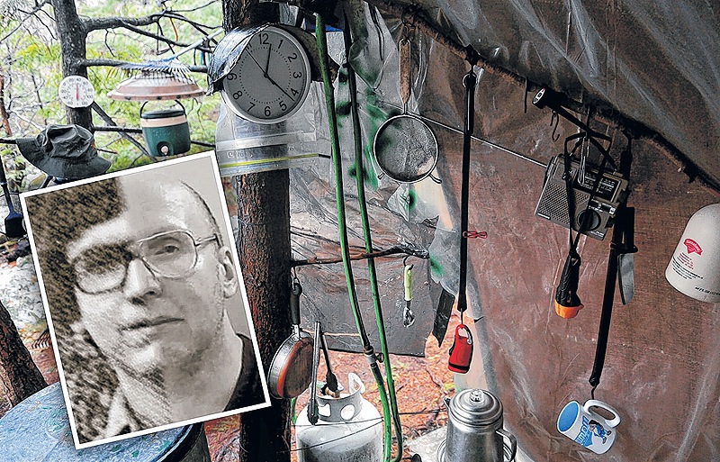 Coffee cups, lights and a clock hang under a tarp in Christopher Knight’s camp in a remote, wooded section of Rome where he is thought to have lived since the 1990s. Police believe Knight, who went into the woods near Belgrade in 1986, committed hundreds of burglaries.