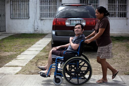 Jacinto Rodriguez Cruz, 49, leaves his home in a wheelchair with the help of his wife, Belen Hernandez, in Veracruz, Mexico, recently. Cruz and another friend suffered serious injuries during a car accident in May 2008 in northwestern Iowa. After their employers' insurance coverage ran out, Cruz, who was not a legal citizen, was placed on a private airplane and flown to Mexico still comatose and unable to discuss his care or voice his protest.