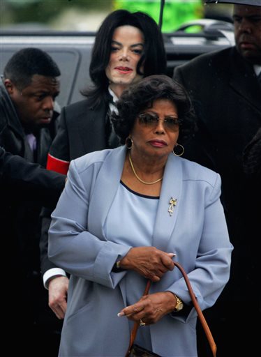 In this Feb. 28, 2005, photo, Michael Jackson follows his mother, Katherine Jackson, as they arrive for court on the opening day of his child molestation trial at Santa Barbara County Superior Court in Santa Maria, Calif.