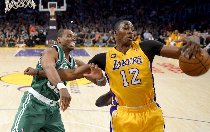 Boston Celtics center Jason Collins battles Los Angeles Lakers center Dwight Howard (12) for a rebound during the first half of their NBA basketball game, Wednesday, Feb. 20, 2013 in Los Angeles. NBA veteran center Collins has become the first male professional athlete in the major four American sports leagues to come out as gay. Collins wrote a first-person account posted Monday, April 29, 2013 on Sports Illustrated's website. (AP Photo/Mark J. Terrill, File)
