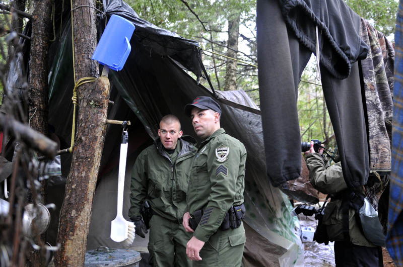 Game Warden Sgt. Terry Hughes, right, and District Warden Dave Ross inspect Christopher Knight's camp Tuesday.