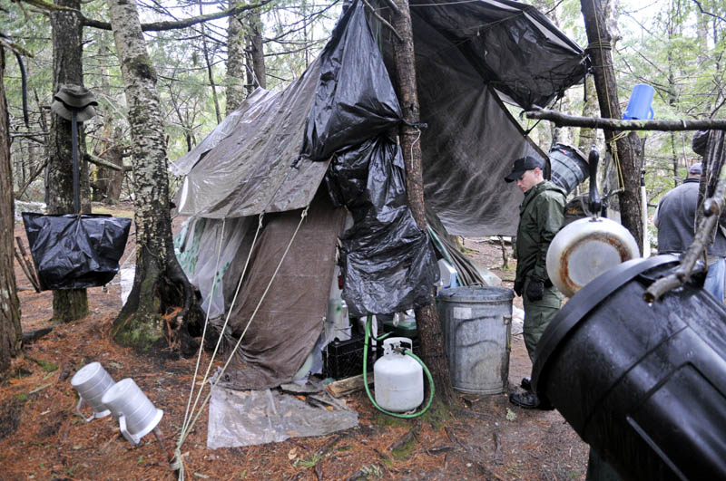 District Game Warden Aaron Cross inspects Christopher Knight's camp Tuesday.