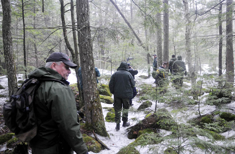 Game wardens, state police and Somerset County sheriff's deputies hike to Christopher Knight's campsite in Rome Tuesday.