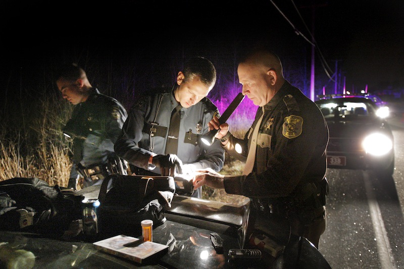 In this 2007 file photo, Maine State Police trooper Leonard Bolton, center, searches a vehicle with two other law-enforcement officers during a traffic stop in Gray. The FBI asked Bolton to help track the Boston Marathon bomb suspect because of his expertise in cellphone analysis.