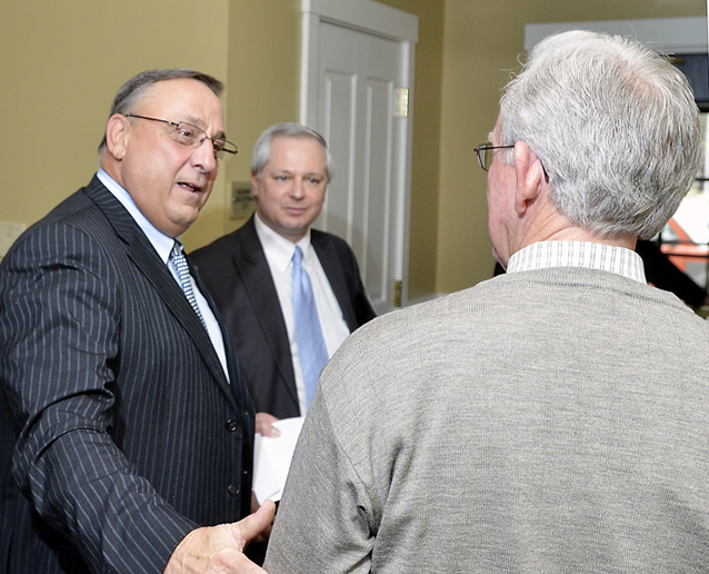 Gov. Paul LePage chats with Charles Wallace, president of Resource Systems Engineering in Brunswick, one of many business leaders who attended Wednesday's event hosted by Southern Midcoast Maine Chamber, which took place at the Inn at Brunswick Station. At center is John Butera, LePage's senior economic adviser.