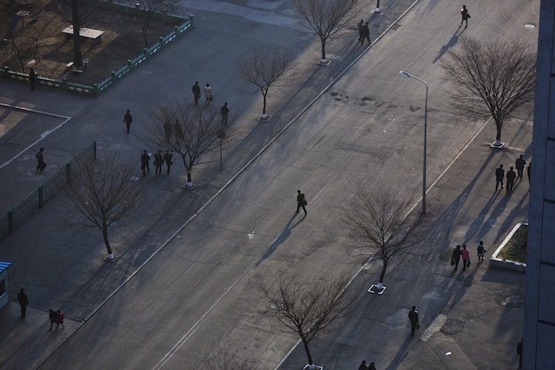 A North Korean commuter crosses a street in central Pyongyang on Wednesday, April 10, 2013. (AP Photo/David Guttenfelder)