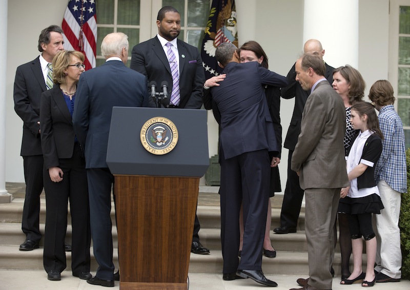 President Barack Obama hugs Nicole Hockley, mother of Dylan who was killed in the Newtown School shootings, during conference in the Rose Garden of the White House, Wednesday, April 17, 2013, in Washington, about measures to reduce gun violence, as he is joined by former Rep. Gabby Giffords, second from left, Vice President Joe Biden, and other Newtown family members from left, Neil Heslin, father of Jesse Lewis; Jimmy Greene, father of Ana; Mark and Jackie Barden, with their children Natalie and James, who lost Daniel; and Jeremy Richman, father of Avielle, behind the Barden's.(AP Photo/Carolyn Kaster)