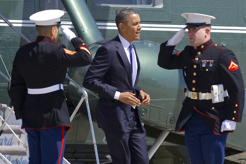 Marines salute as President Barack Obama jogs off of the Marine One helicopter before boarding Air Force One at Andrews Air Force Base, Md., Wednesday April 3, 2013, en route to Colorado. (AP Photo/Jacquelyn Martin)