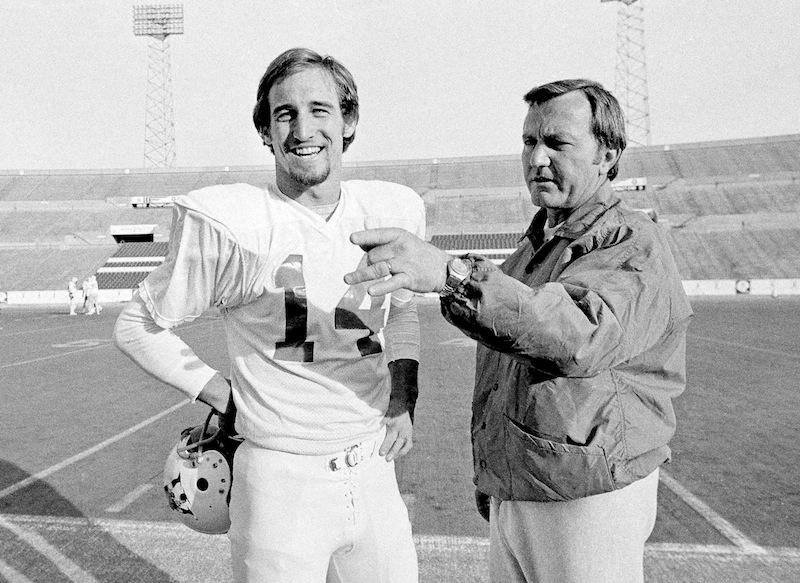 In this Dec. 15, 1976 file photo, New England Patriots Coach Chuck Fairbanks, right, makes a point as he discusses play with quarterback Steve Grogan, during a workout at Schaefer Stadium in Foxborough, Mass., as they prepared for playoff game against the Oakland Raiders. Fairbanks, who coached Heisman Trophy winner Steve Owens at Oklahoma and spent six seasons as coach of the New England Patriots, died Tuesday, April 2, 2013, in Scottsdale, Ariz., after battling brain cancer, the University of Oklahoma said in a news release. He was 79. (AP Photo/File) Coah;Football;Gesturing;Player;Professsional;Quarterback;Stadium;Talking