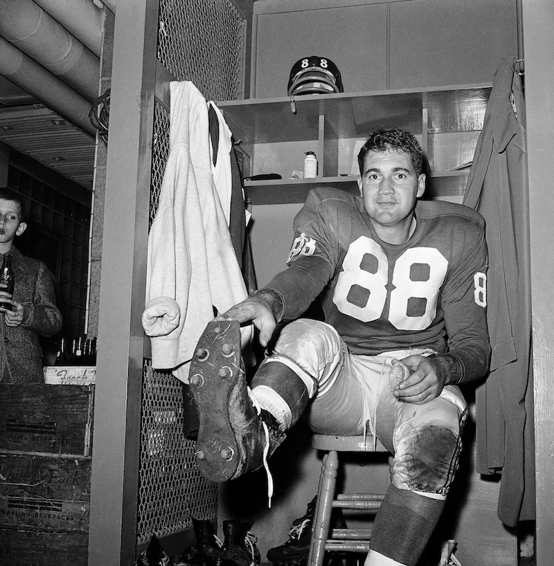 In this Nov. 8, 1959, file photo, New York Giants place kicker Pat Summerall shows off kicking shoe for photographers in the locker room after making three field goals to help the team to a 9-3 win over the Chicago Cardinals at Yankee Stadium in New York. Fox Sports spokesman Dan Bell said Tuesday, April 16, 2013, that Summerall, the NFL player-turned-broadcaster whose deep, resonant voice called games for more than 40 years, has died at the age of 82. (AP Photo/John Lindsay, File)