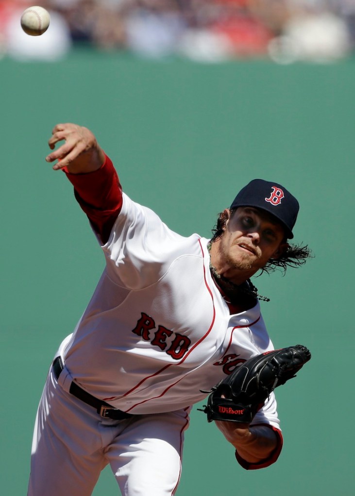 Boston Red Sox starting pitcher Clay Buchholz (11) delivers to the Baltimore Orioles during the first inning of a baseball game at Fenway Park in Boston, Monday, April 8, 2013. (AP Photo/Elise Amendola) Fenway Park