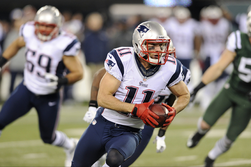 Julian Edelman returns a Jets fumble for a Patriots touchdown during a game last season. The Patriots have re-signed Edelman.