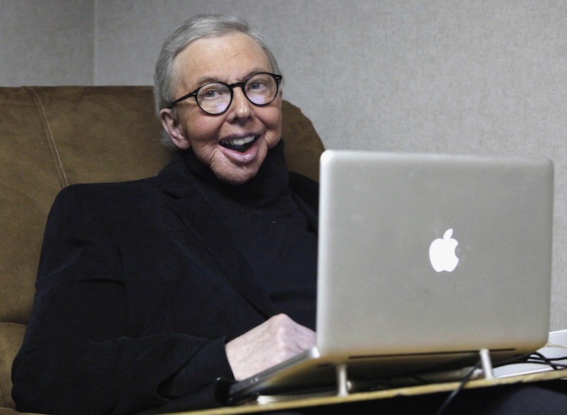 In this Jan. 12, 2011 file photo, Pulitzer Prize-winning movie critic Roger Ebert works in his office at the WTTW-TV studios in Chicago. In an essay posted Tuesday, April 2, 2013, Ebert says that he has cancer again and is scaling back his movie reviews while undergoing radiation. The veteran critic has previously battled cancer in his thyroid and salivary glands and lost the ability to speak and eat after surgery. (AP Photo/Charles Rex Arbogast, File)