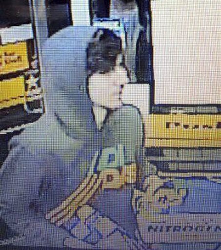 This surveillance photo released via Twitter on Friday by the Boston Police Department shows a suspect entering a convenience store that police are pursuing in Watertown, Mass. Police say he is one of two suspects in the fatal shooting of an MIT police officer and tied to the Boston Marathon bombing.