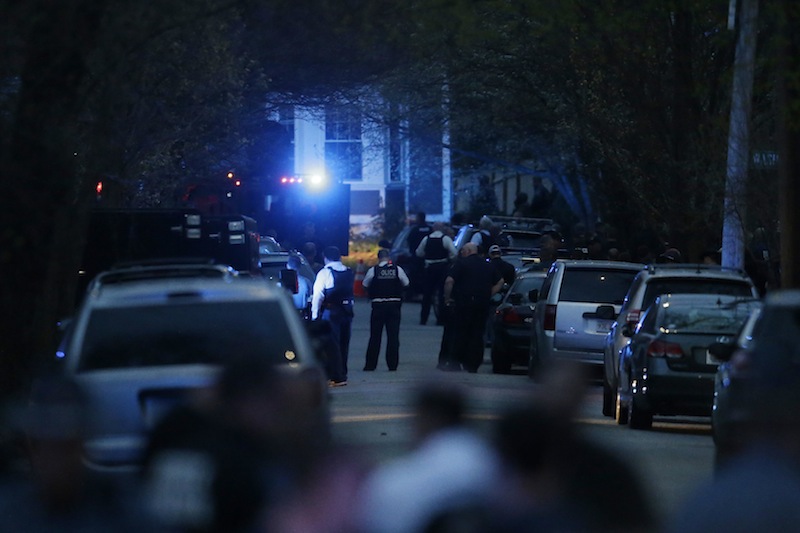 Law enforcement search for the suspect in the Boston Marathon bombings, Friday, April 19, 2013, in Watertown, Mass., where he was ultimately captured after a lengthy shootout. (AP Photo/Matt Rourke)