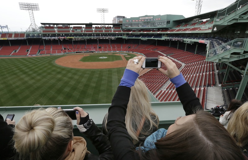 Fans shoot photos from the Green Monster seats during a tour of Fenway Park in Boston Friday, April 5, 2013. The Boston Red Sox baseball home opener is scheduled for Monday against the Baltimore Orioles. (AP Photo/Elise Amendola)