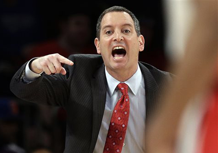In this March 12, 2013, photo, Rutgers coach Mike Rice yells out to his team during a game against DePaul in the Big East tournament in New York.