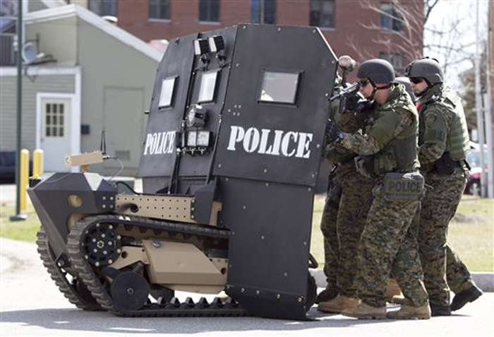 A remote-controlled small tank-like vehicle with a shield for officers, is demonstrated for the media in Sanford on Thursday, Howe & Howe Technologies, a Waterboro company, says their device can keep first responders safe in standoffs and while confronting armed suspects.