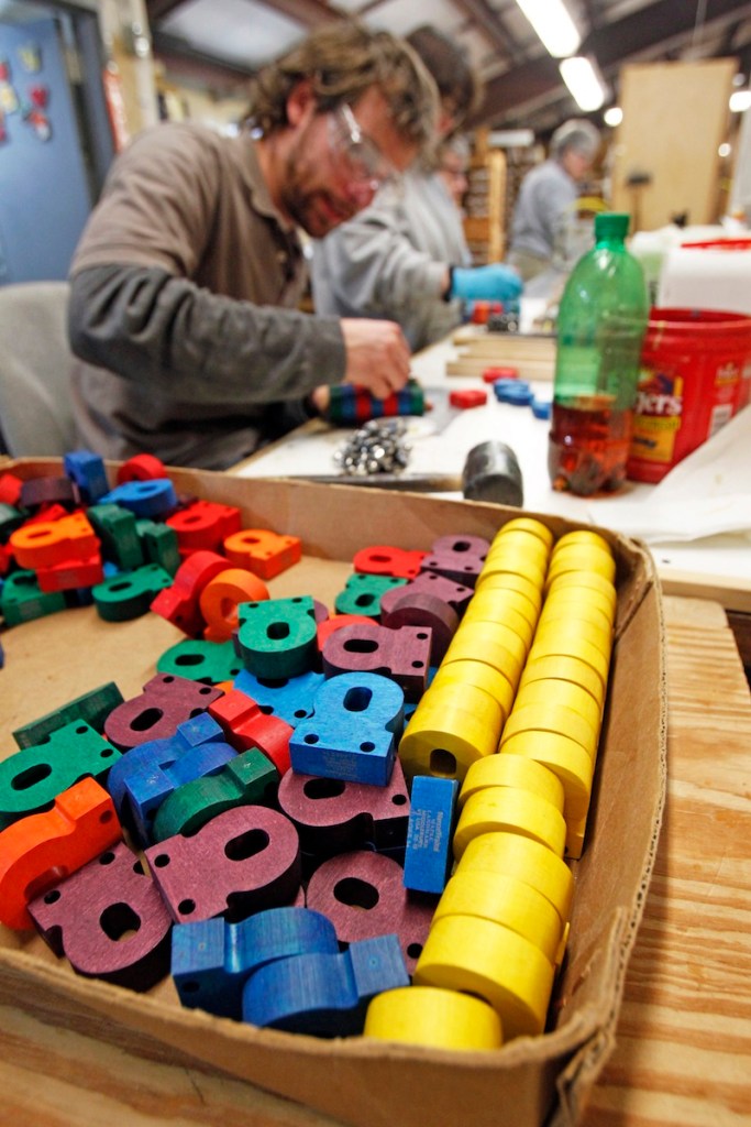 In this Friday, Feb. 22, 2013, photo, a worker assembles wooden toys at the Maple Landmark Woodcraft factory in Middlebury, Vt. Experts say family businesses are more resilient when times are tough because of relative’s commitment, passion and knowledge of the business. (AP Photo/Toby Talbot)