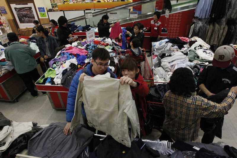 Customers choose clothes at a Lotte Mart in Seoul, South Korea, on Friday. Outsiders might hear the opening notes of a war in the deluge of threats and provocations from North Korea, but to South Koreans it is a familiar song.