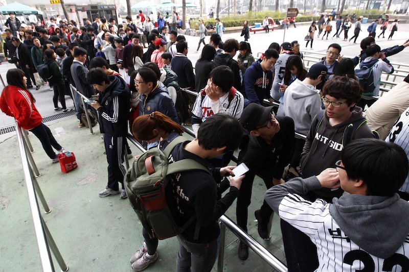People line up to buy tickets for a pro baseball game at the Jamsil Baseball Stadium in Seoul, South Korea on Friday. Outsiders might hear the opening notes of a war in the deluge of threats and provocations from North Korea, but to South Koreans it is a familiar song.