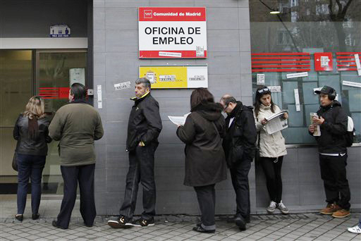 People wait outside an unemployment office in Madrid, Spain, on Tuesday. The number registered as unemployed stands at 5.04 million as Spain battles to emerge from its second recession in just over three years.