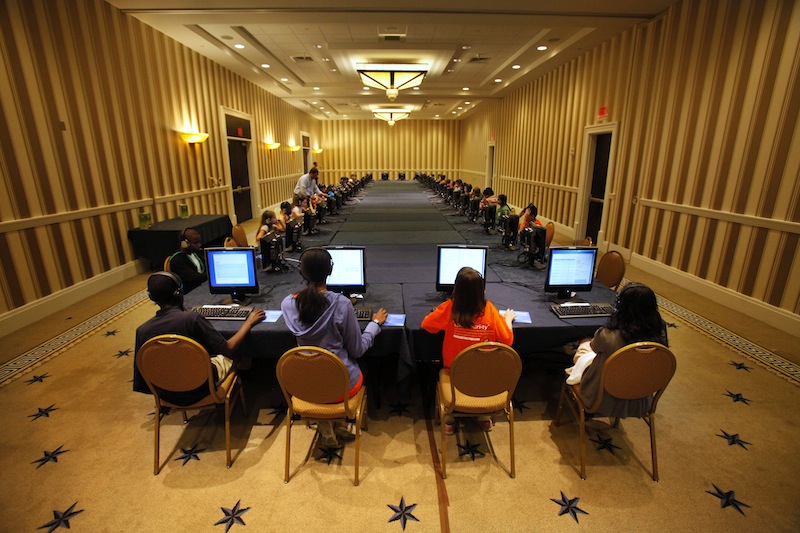 In this May 29, 2012 file photo, contestants in the National Spelling Bee take the written exam on computers in Oxon Hill, Md., before the oral competition began. Ever wonder if those spelling bee kids know the meanings of some of those big words? Now they'll have to prove that they do. Organizers of the Scripps National Spelling Bee on Tuesday announced a major change to the format, adding multiple-choice vocabulary tests to the annual competition that crowns the English language's spelling champ. (AP Photo/Jacquelyn Martin, File)