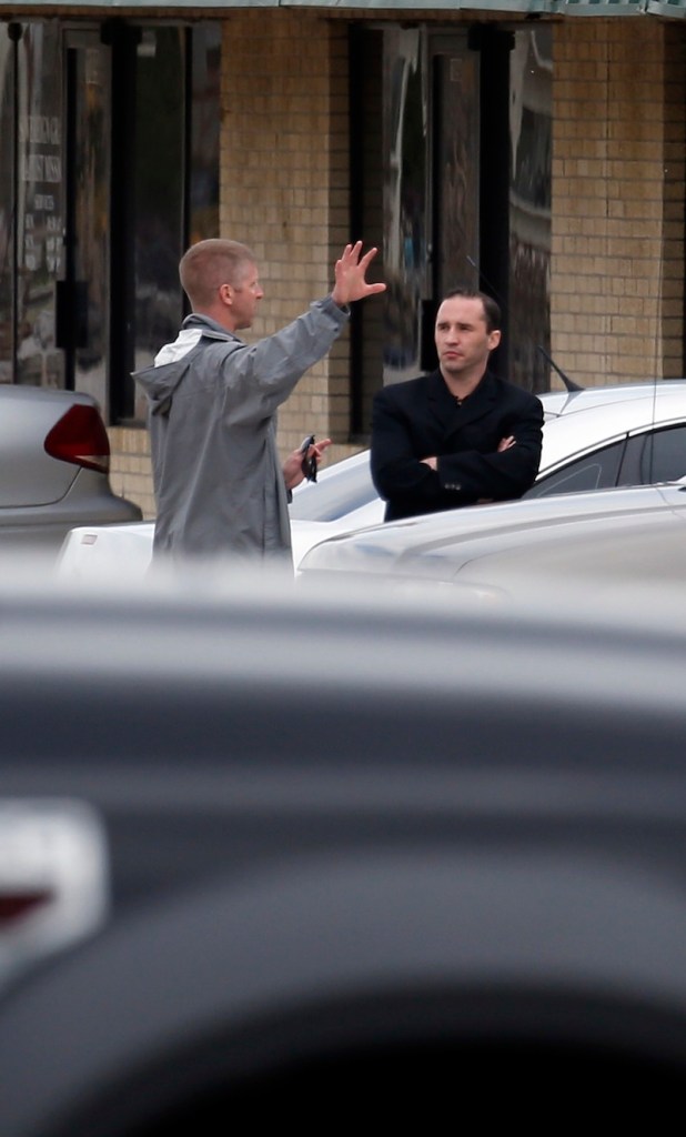 Everett Dutschke, right, confers with a federal agent near the site of a martial arts studio he once operated, Wednesday, April 24, 2013 in Tupelo, Miss. The property was being searched in connection with the investigation into poisoned letters mailed to President Barack Obama and others. Dutschke has not been arrested or charged. (AP Photo/Rogelio V. Solis)