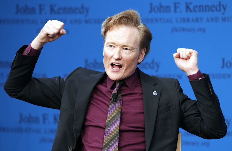 This May 24, 2012 file photo shows late night talk show host Conan O'Brien speaking during a forum at the John F. Kennedy Presidential Library in Boston. TBS says it's extending Conan O'Brien's late-night hour through November 2015.