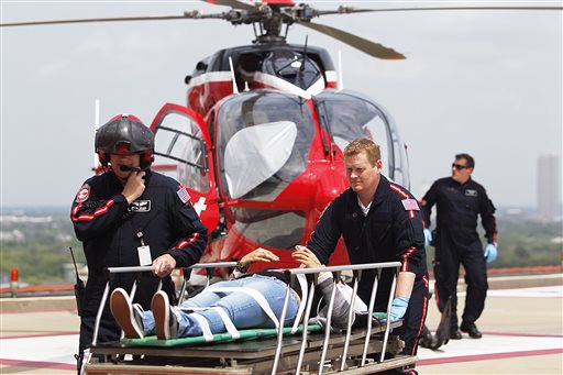 Emergency personnel rush a victim to a LifeFlight helicopter after a stabbing attack on the Lone Star Community College System's Cypress, Texas, campus on Tuesday.