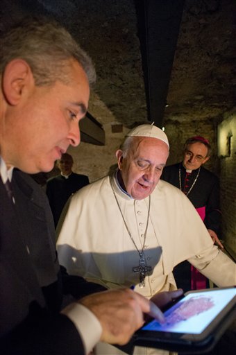 In this picture made available by the Vatican newspaper L'Osservatore Romano, Pope Francis, center, visits the necropolis under St. Peter's Basilica at the Vatican.